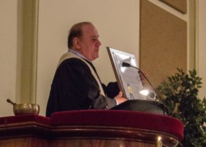 Roger Peltier holding the resolution